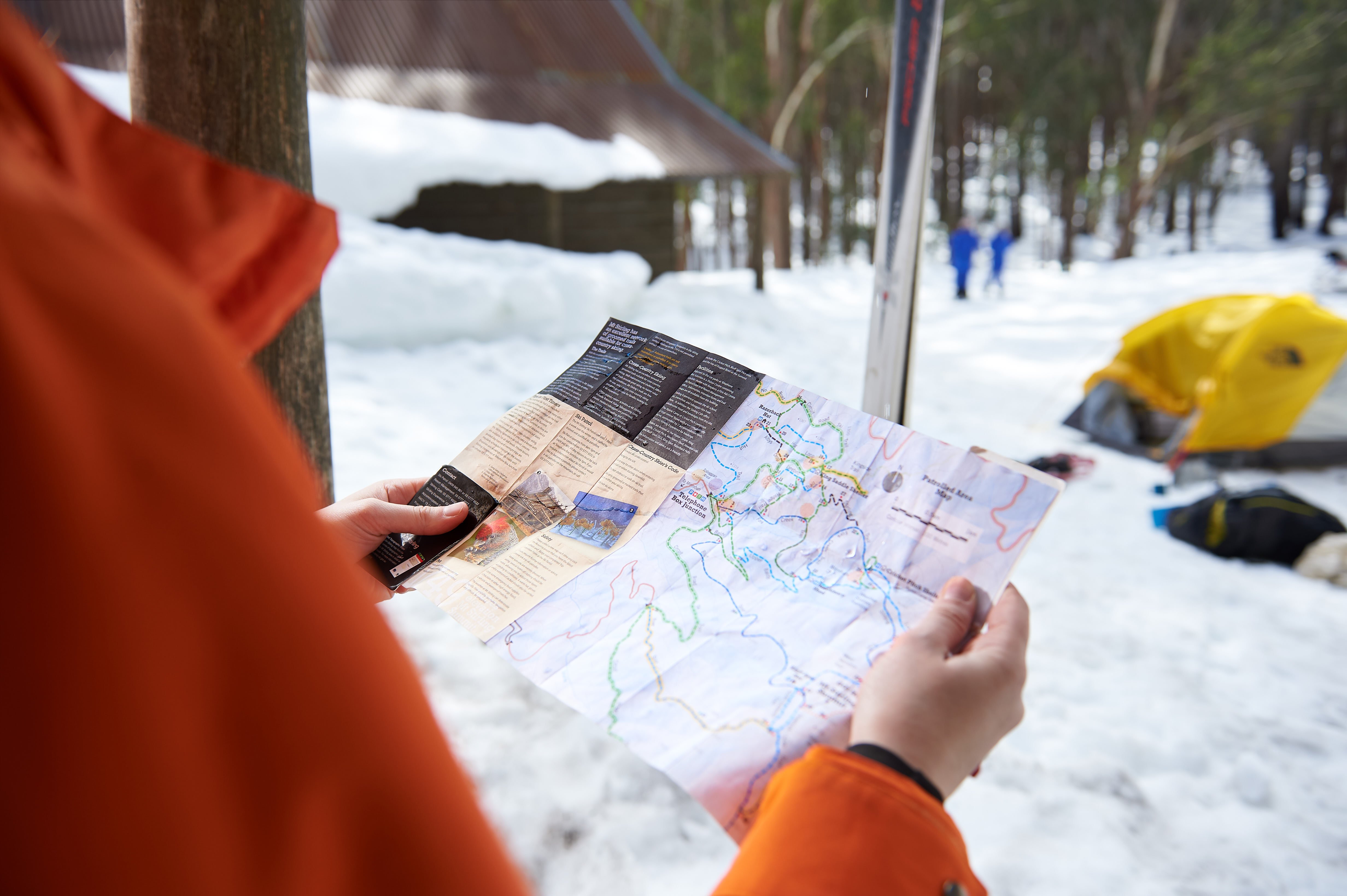 Guest using a map to find their way in the snowy village